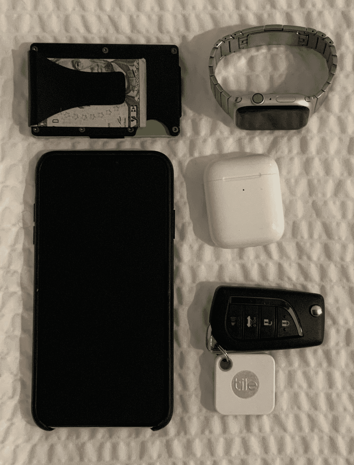 Thought I would inspire myself with Adam Savage's knolling posts.  Layflat knolling of phone, keys, wallet, AirPods and tile.
